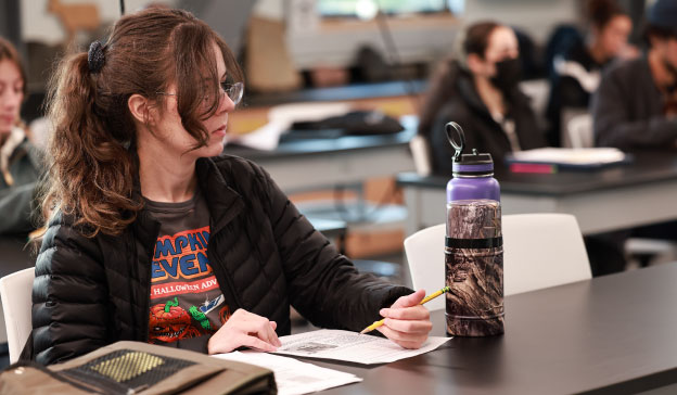 anthropology and archaeology student taking notes in class