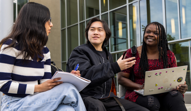 Three College Students Discussing Communication Studies Outdoors